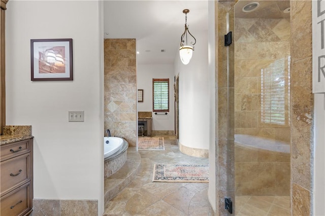 full bath featuring a shower stall, a garden tub, and vanity