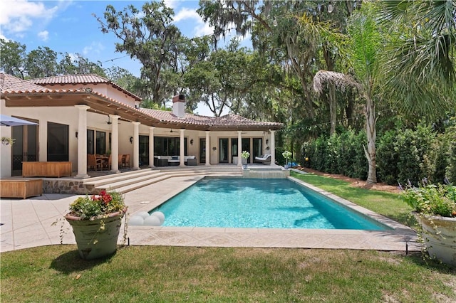 pool with outdoor lounge area, a ceiling fan, and a patio