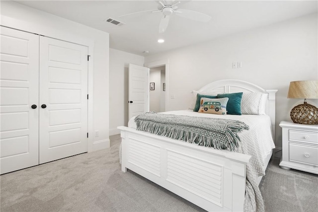 bedroom with ceiling fan, a closet, and light carpet