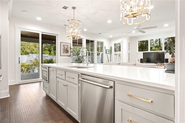 kitchen with sink, hanging light fixtures, stainless steel dishwasher, dark hardwood / wood-style flooring, and wall oven