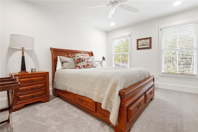 bedroom with ceiling fan and light colored carpet