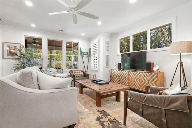 living room with crown molding and ceiling fan