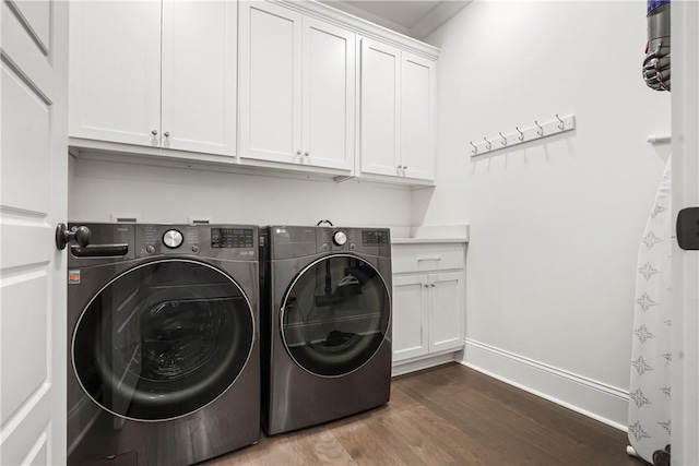 laundry area with cabinets, dark hardwood / wood-style floors, and independent washer and dryer