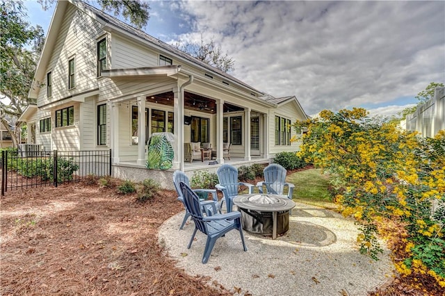 rear view of house featuring an outdoor fire pit and a patio area