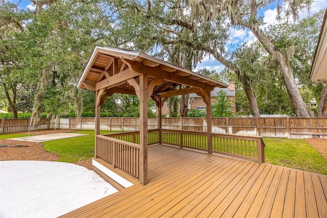 wooden deck featuring a gazebo, a yard, and a patio area