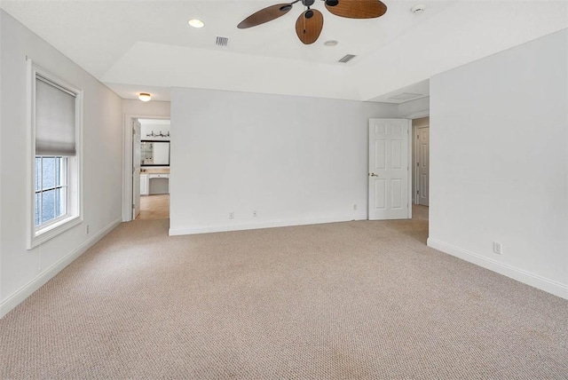 unfurnished room featuring light carpet and ceiling fan