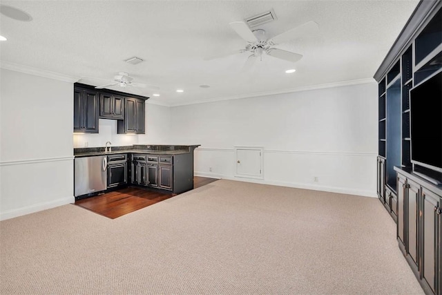 kitchen with crown molding, sink, stainless steel dishwasher, and dark colored carpet