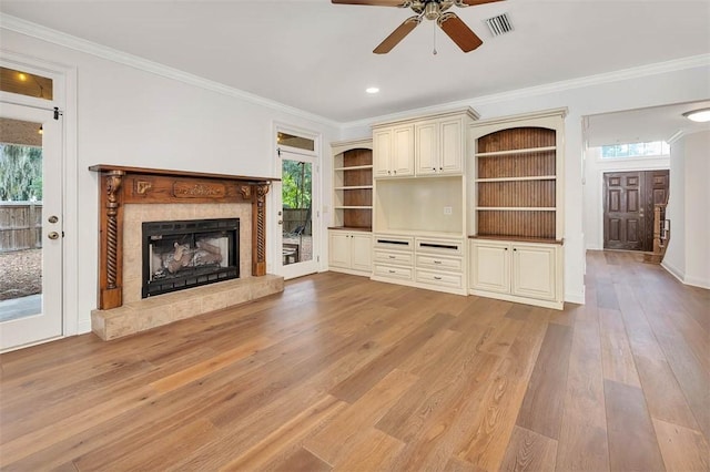 unfurnished living room with light hardwood / wood-style flooring, a healthy amount of sunlight, and crown molding