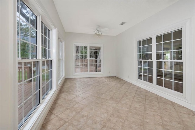 unfurnished sunroom featuring ceiling fan