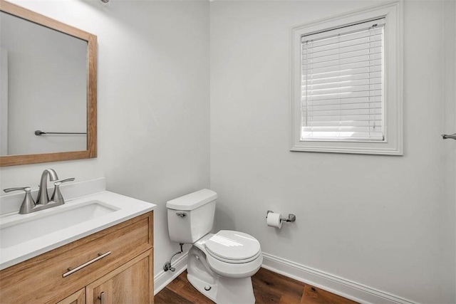 bathroom featuring vanity, wood-type flooring, and toilet