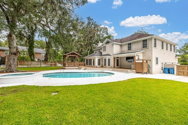 view of pool featuring an in ground hot tub, a gazebo, and a yard