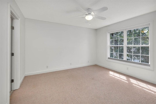 unfurnished room featuring ceiling fan and light carpet