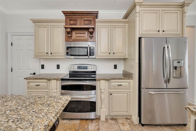 kitchen with cream cabinetry, stainless steel appliances, light stone counters, and ornamental molding