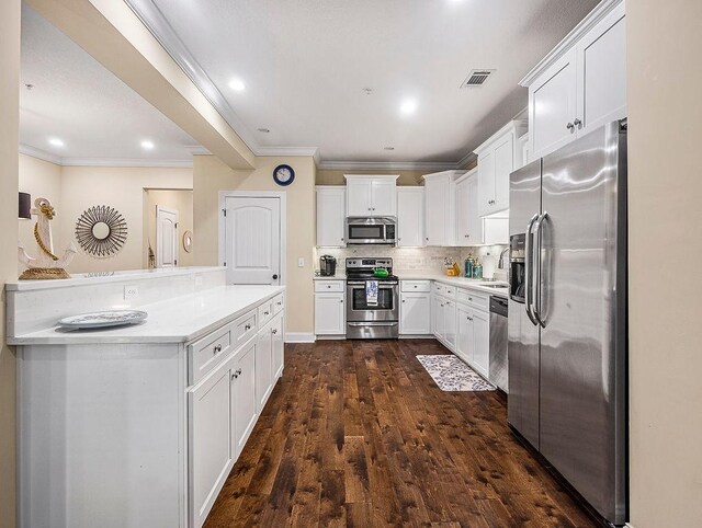 kitchen with sink, stainless steel appliances, dark hardwood / wood-style flooring, backsplash, and white cabinets