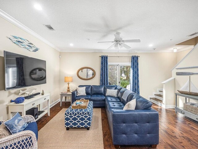 living room with crown molding, ceiling fan, dark hardwood / wood-style floors, and a textured ceiling