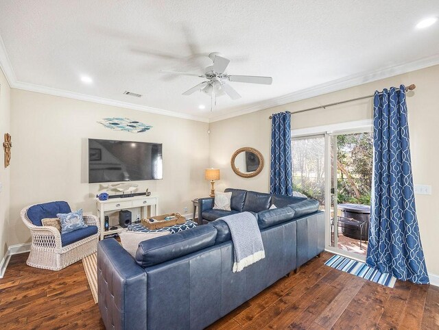 living room featuring dark hardwood / wood-style floors, ceiling fan, ornamental molding, and a textured ceiling