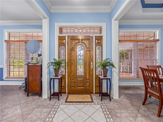 entryway with crown molding, arched walkways, plenty of natural light, and baseboards