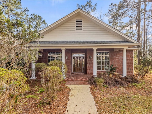 view of front of home with brick siding and a front yard