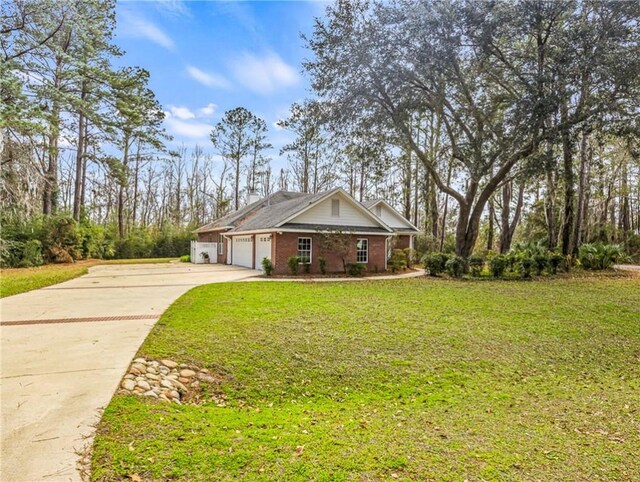 view of front facade with a front yard, brick siding, driveway, and an attached garage