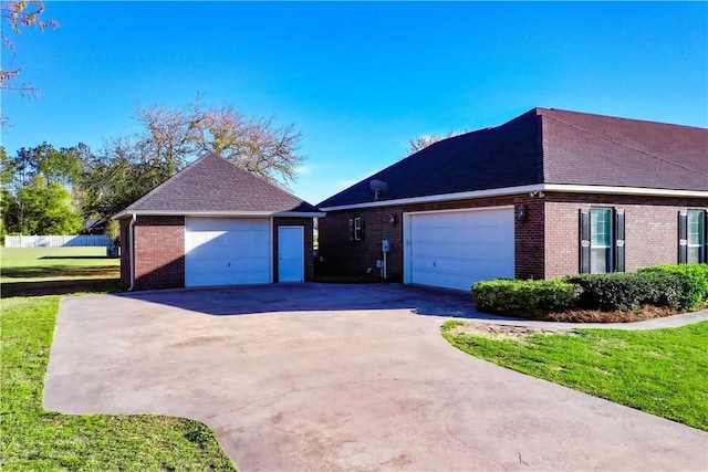 6121 Stoney Brook Dr, Blackshear, GA 31516 - view of front of house featuring driveway, a front yard, a shingled roof, a garage, and brick siding