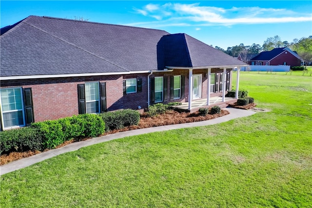 6121 Stoney Brook Dr, Blackshear, GA 31516 - view of front facade with a front yard, brick siding, covered porch, and a shingled roof