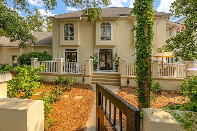 407 Butler Ave, Saint Simons Island, GA 31522 - view of front of home featuring stucco siding and roof with shingles