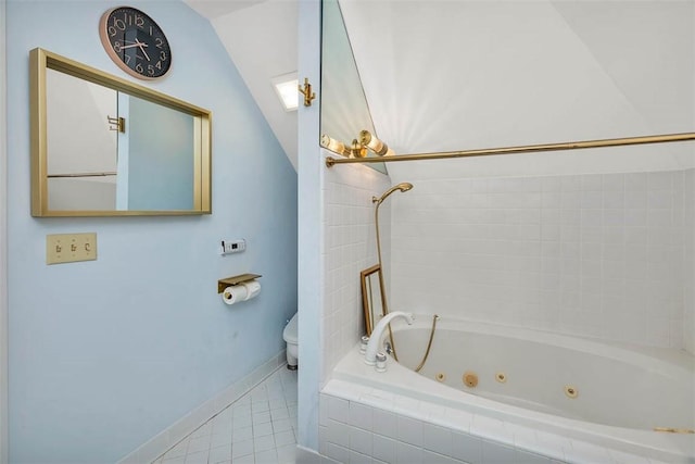 407 Butler Ave, Saint Simons Island, GA 31522 - full bath with toilet, tile patterned floors, a combined bath / shower with jetted tub, baseboards, and vaulted ceiling