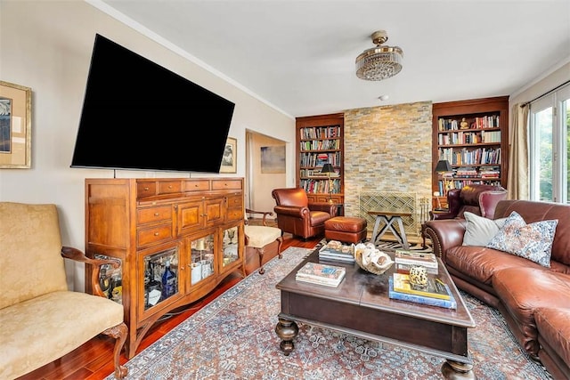 407 Butler Ave, Saint Simons Island, GA 31522 - living area with wood finished floors, built in shelves, crown molding, and a fireplace