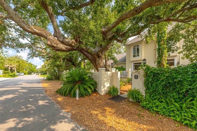 407 Butler Ave, Saint Simons Island, GA 31522 - exterior space featuring a fenced front yard, stucco siding, and a gate