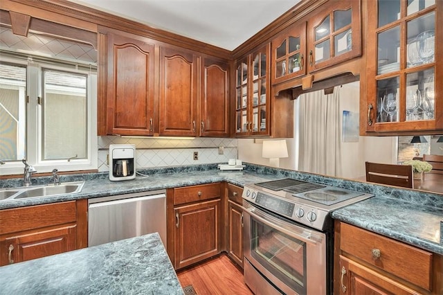 407 Butler Ave, Saint Simons Island, GA 31522 - kitchen featuring appliances with stainless steel finishes, a sink, dark countertops, and backsplash