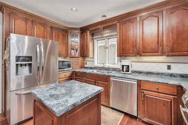 407 Butler Ave, Saint Simons Island, GA 31522 - kitchen featuring appliances with stainless steel finishes, a sink, tasteful backsplash, and brown cabinetry