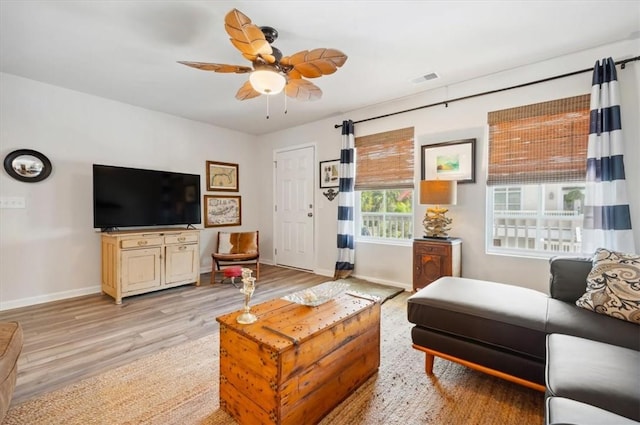 102 Cathead Ln, Darien, GA 31305 - living area with light wood-style floors, visible vents, baseboards, and a ceiling fan