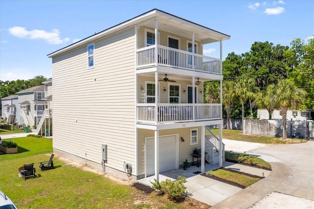 102 Cathead Ln, Darien, GA 31305 - exterior space featuring a balcony, a yard, a ceiling fan, an attached garage, and concrete driveway