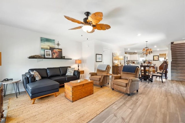102 Cathead Ln, Darien, GA 31305 - living room featuring light wood-style flooring, ceiling fan with notable chandelier, and recessed lighting