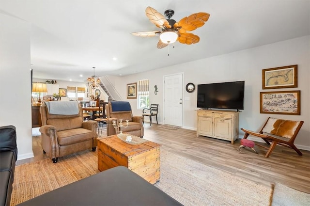 102 Cathead Ln, Darien, GA 31305 - living room with baseboards, ceiling fan, stairway, and light wood-type flooring