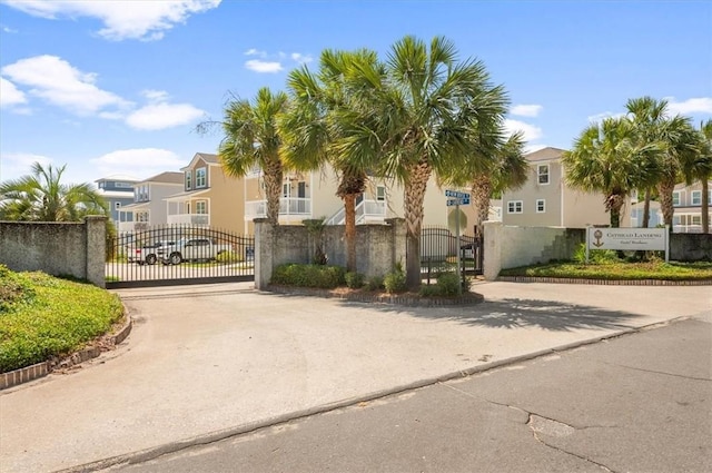 102 Cathead Ln, Darien, GA 31305 - exterior space with driveway, fence, stucco siding, a residential view, and a gate