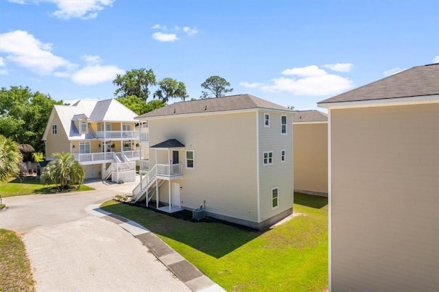102 Cathead Ln, Darien, GA 31305 - back of property with a balcony, a lawn, and stairs
