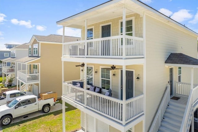 102 Cathead Ln, Darien, GA 31305 - exterior space featuring a balcony, stairs, roof with shingles, and ceiling fan