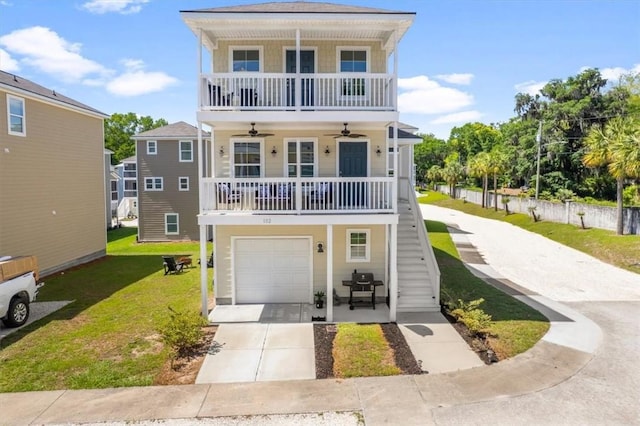 102 Cathead Ln, Darien, GA 31305 - view of front of property with a ceiling fan, driveway, an attached garage, stairs, and a front lawn