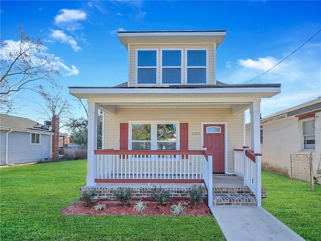 view of front of home featuring covered porch and a front lawn