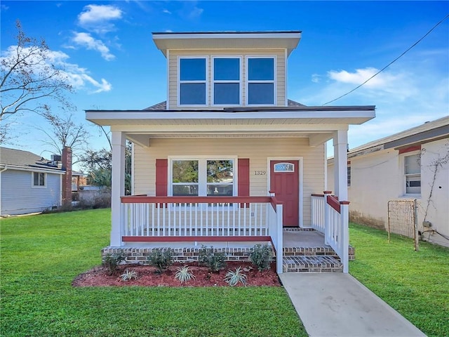 view of front facade featuring covered porch and a front yard