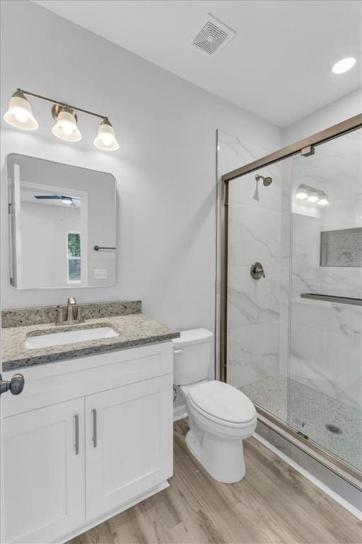 1329 New Castle St, Savannah, GA 31415 - full bath with toilet, wood finished floors, vanity, and a marble finish shower