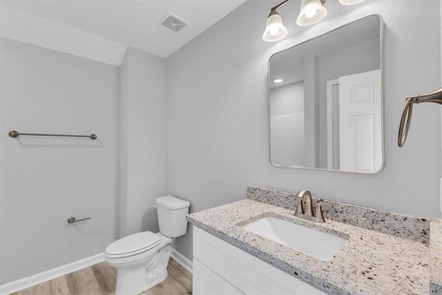 1329 New Castle St, Savannah, GA 31415 - bathroom featuring vanity, wood finished floors, baseboards, and toilet