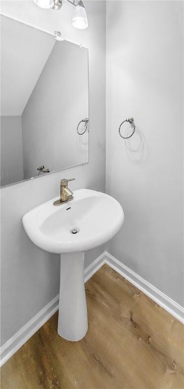 bathroom with wood-type flooring and sink