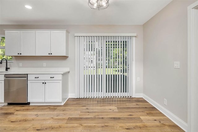 2503 Cleburne St, Brunswick, GA 31520 - kitchen featuring stainless steel dishwasher, light countertops, white cabinets, light wood-type flooring, and recessed lighting