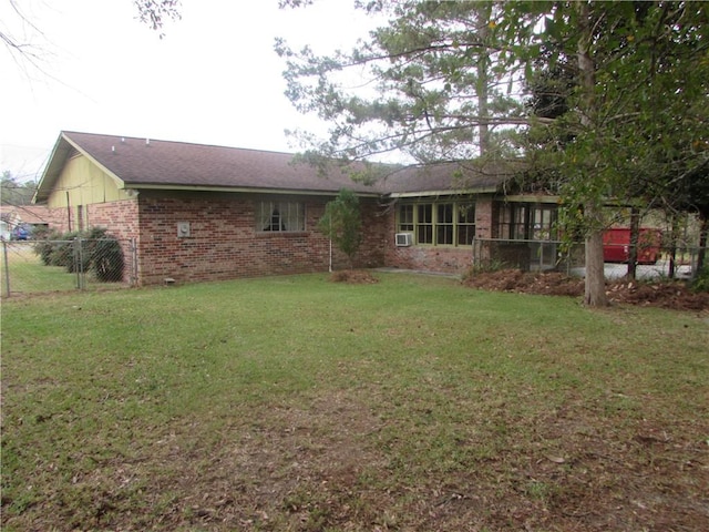 rear view of property featuring a yard