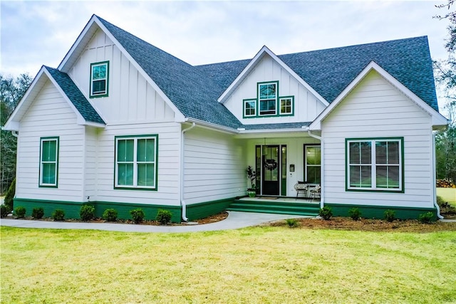 modern inspired farmhouse featuring board and batten siding, a front yard, a shingled roof, and a porch