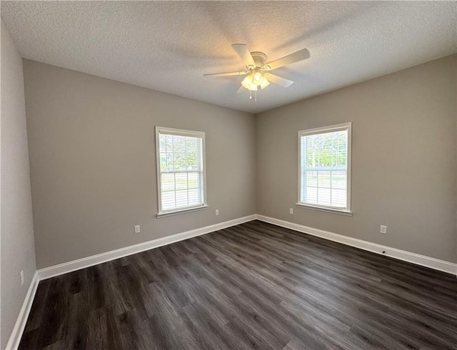 1029 N Church St, Odum, GA 31555 - unfurnished room with dark wood-style flooring, plenty of natural light, a ceiling fan, baseboards, and a textured ceiling