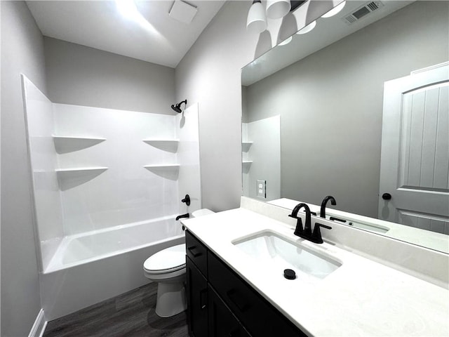 1029 N Church St, Odum, GA 31555 - bathroom with wood finished floors, toilet, vanity, and  shower combination