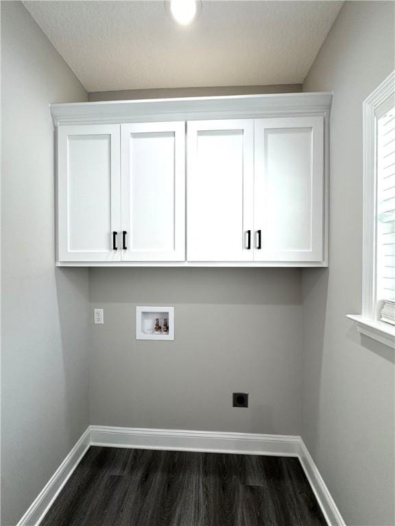 1029 N Church St, Odum, GA 31555 - laundry area featuring electric dryer hookup, dark wood-style floors, cabinet space, and washer hookup